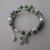 Moss green agate with Swarovski pearls and olivine crystals, and pewter rondelles, cross, and heart charm.