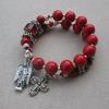 Red riverstone Aves, sterling silver spacers, cathedral crystal Paters, and pewter rondelles, cross, and angel charm