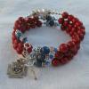 Red fossil beads are the Aves beside blue sodalite Paters and a joiner of Swarovski pearls and crystals in the colors of the Knights of Columbus (KofC charm provided by client)