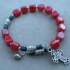 Variation of "Our Lady Bug" with red luster cubes and pewter cross and heart charm.