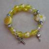 Yellow acrylic with pewter cross and heart charm.