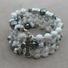 White howlite with grey Czech glass, pewter cross, and diamond-cut aluminum accents.