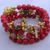 Red fossil with cloisonne Paters, gold Bali joiner, and gold plated spacers, rondelles, and cross.
