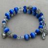 Royal blue cat's eye, clear Swarovski crystals, pewter rose bud beads, rondelles, heart charm, and cross.
