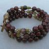 Red-brown jasper with topaz Swarovski crystals and gold filled spacers, rondelles, and diamond-cut cross.
