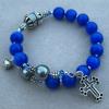 Blue cobalt cat's eye in 8mm with Czech glass Paters and pewter cross, rondelles, and heart charm.